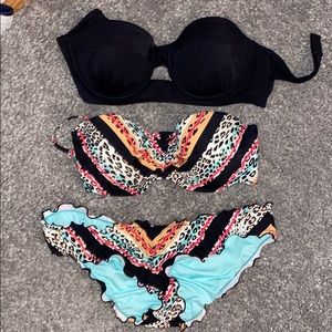 Two bikini tops and a pair of matching bottoms